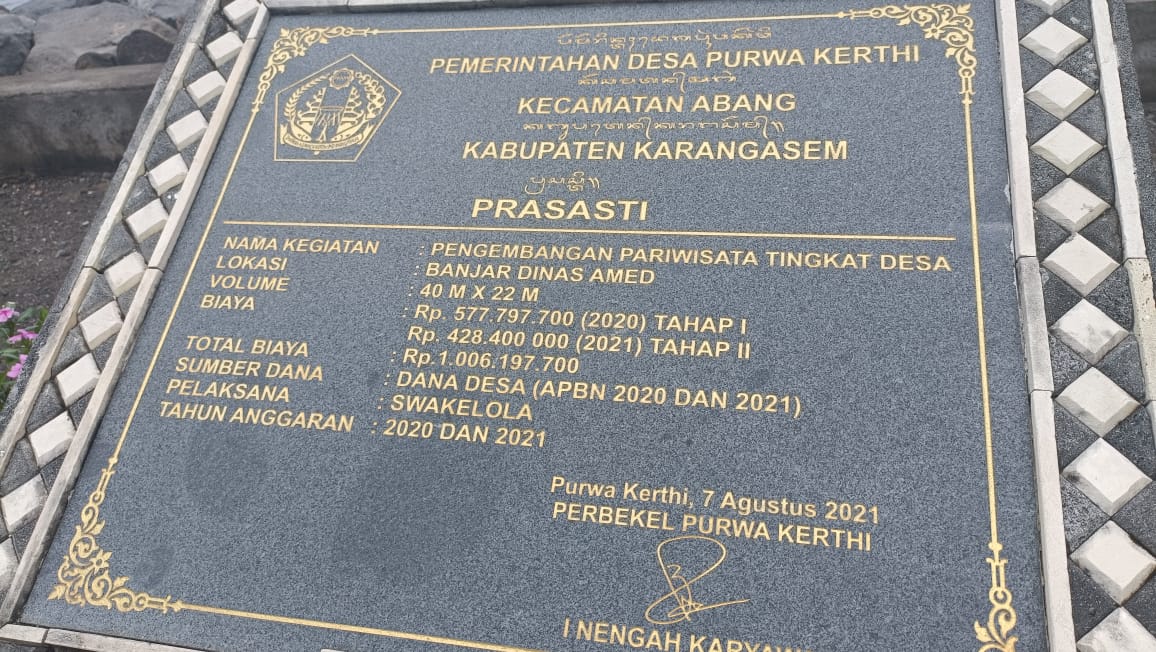 Amed beach Bali2 Marble stone with Information engraved in Indonesian language at Amed beach.