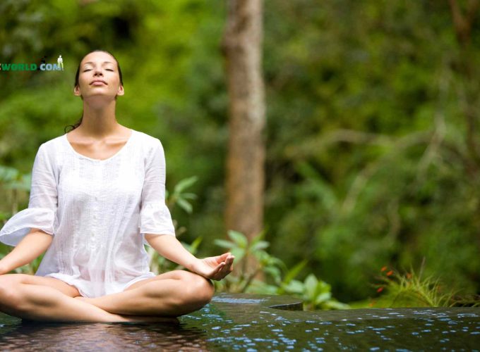 Girl doing yoga asana in Bali's lush forest