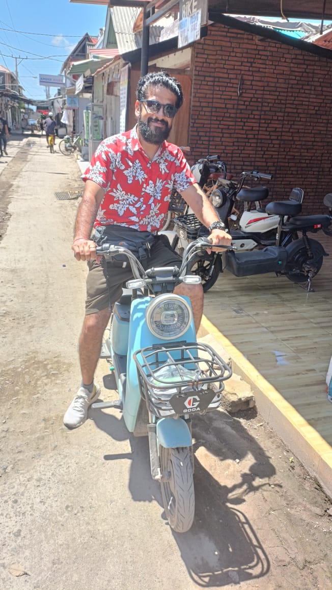Adit Sarin riding electric scooter at Gili Island