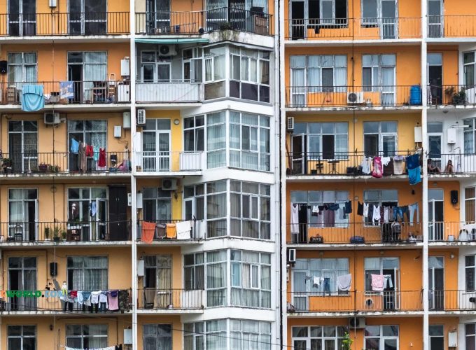 Orange building with balconies and clothes hanging in Batumi city