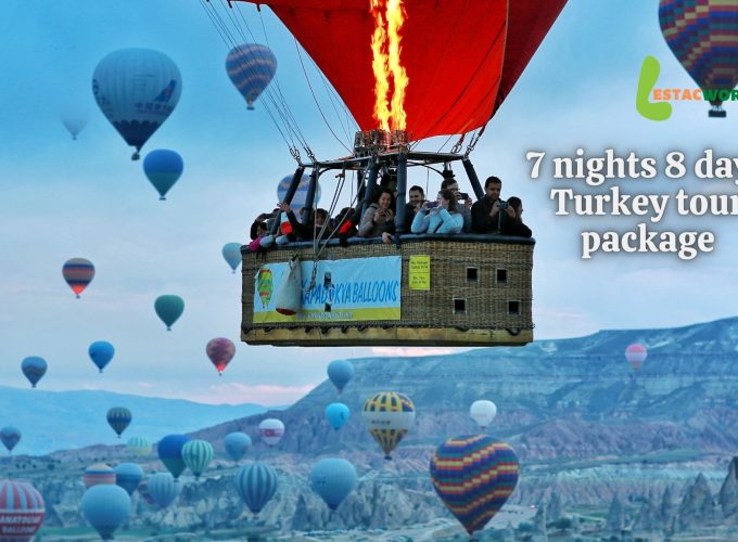 Hot air balloons flying over the surreal landscapes of Cappadocia during the 7 nights 8 days Turkey tour package.