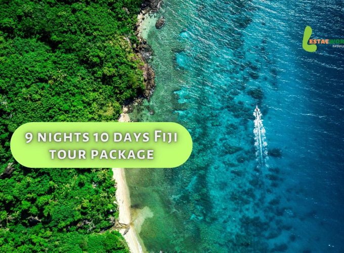 Aerial view of turquoise sea and pristine beach surrounded by lush greenery - 9 nights 10 days Fiji tour package.