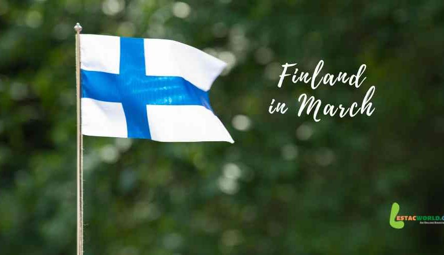 Finland flag waving proudly against a clear March sky - Is March the right time to visit Finland?