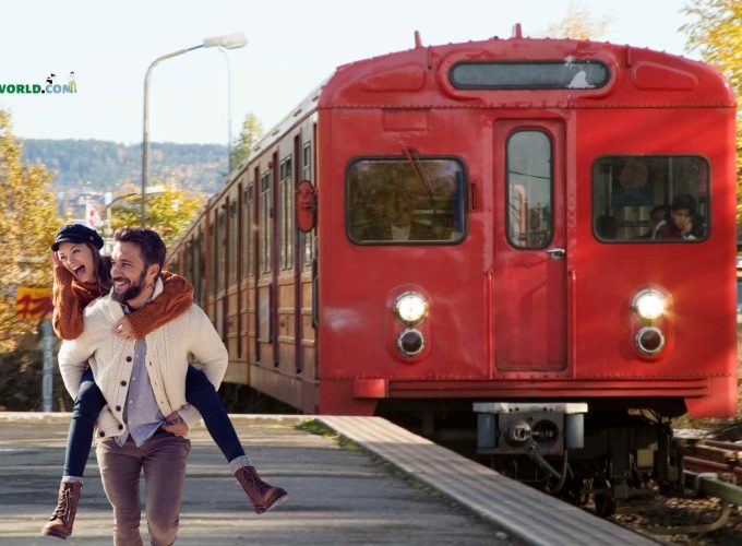 A joyful couple embraces at Oslo Railway Station during their 11 nights 12 days Finland, Norway, Sweden tour package, radiating happiness and wanderlust.