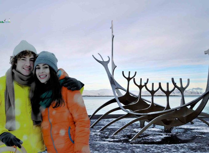 Couple standing in front of Sun Voyager sculpture in Reykjavík during the 8 Nights, 9 Days Iceland, Norway, Sweden & Finland Tour Package.