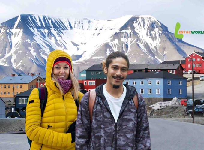 Tourists posing in the captivating landscape of Svalbard, surrounded by Arctic beauty during the Best Scandinavia and Svalbard Tour Package.