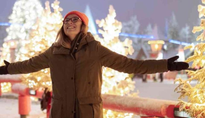 Rubina from Singapore embraces the winter magic in Rovaniemi, Finland, during a group tour on Christmas with Lestacworld.com