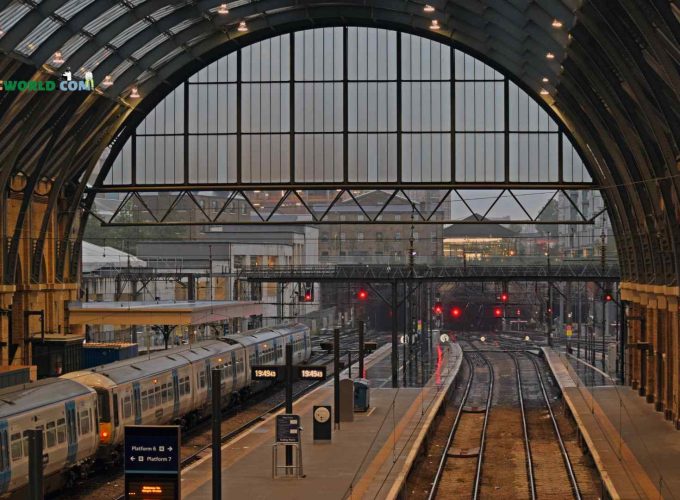 Railway junction in London with trains crossing paths.