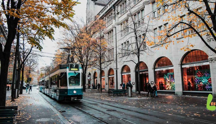 Tram train traveling through picturesque Swiss scenery in autumn