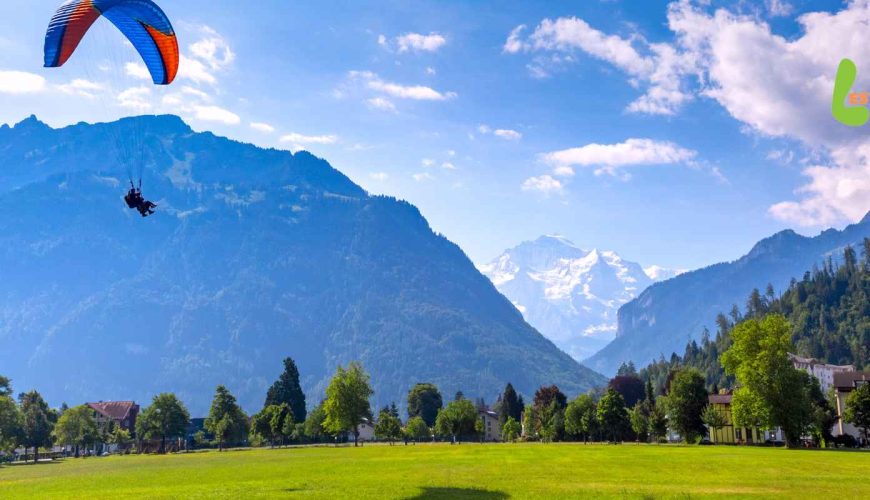 Paraglider soaring over Interlaken's picturesque landscape in September