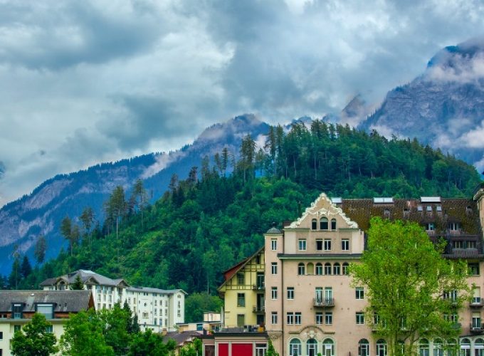 2 nights 3 days Switzerland tour package - Hotel building in Interlaken with Alps in the background, showcasing the beauty of the Swiss landscape.