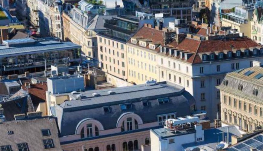 Aerial view of Vienna city skyline with historic landmarks.