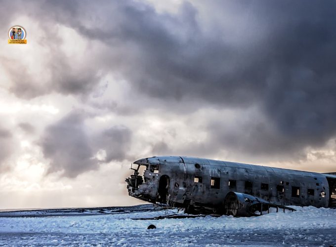 Aerial view of a DC-3 wreck plane surrounded by rugged terrain
