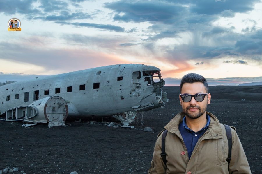 Tourist posing in front of the DC-3 Plane Wreck on the DC-3 Plane Wreck tour from Reykjavik.