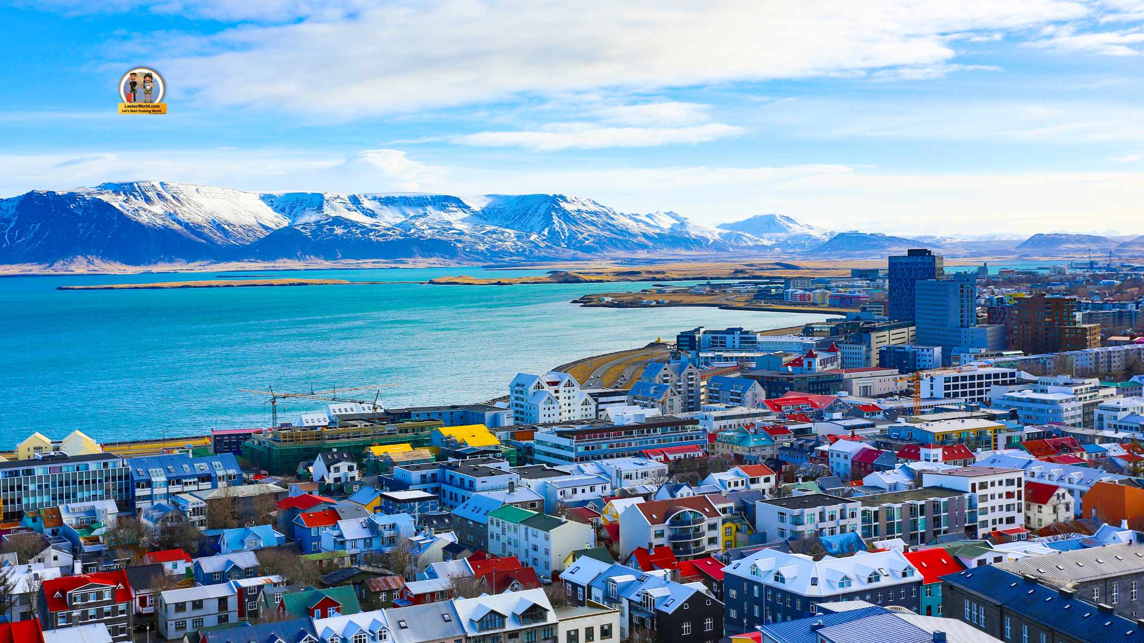 Aerial view of Reykjavik in June, illuminated by the Midnight Sun, showcasing vibrant city lights against a backdrop of lush greenery and clear blue skies.