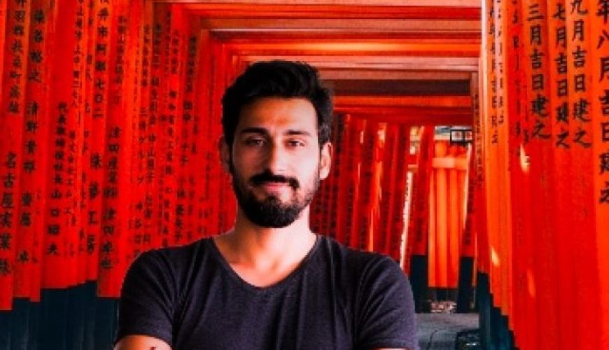 A tourist posing in front of Hie Shrine in Tokyo, Japan.