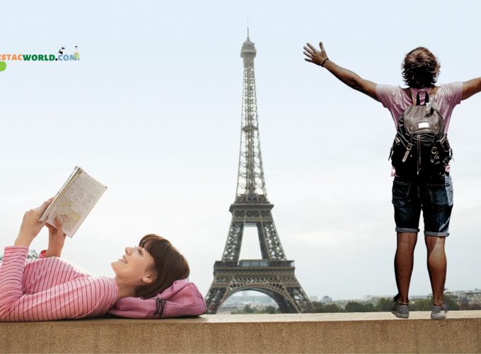 Tourists enjoying panoramic view of Paris from the Eiffel Tower during a 10 nights 11 days France tour package.