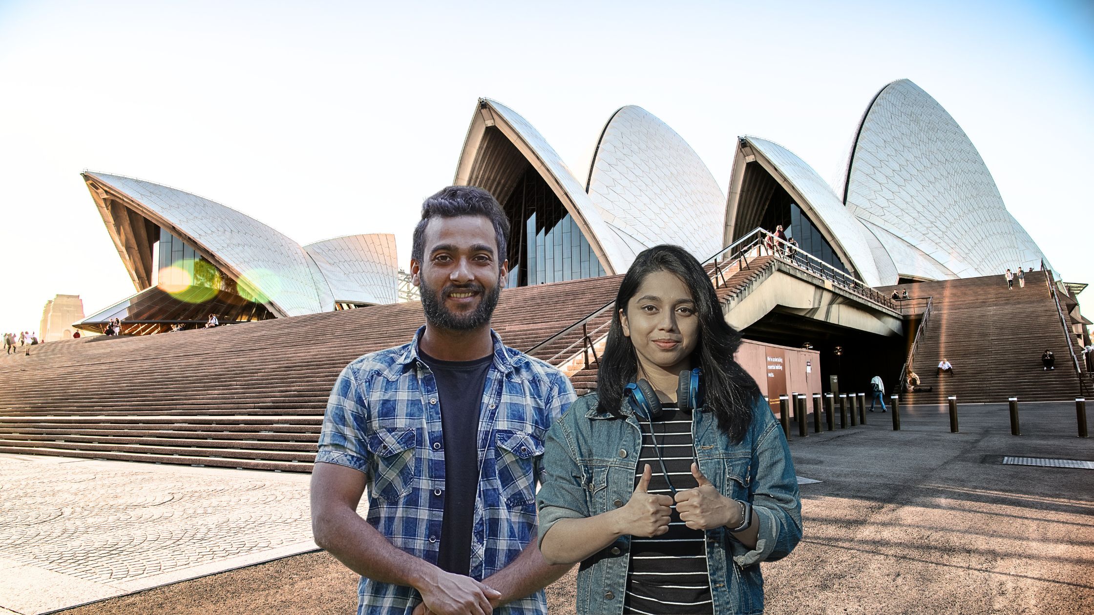 Anjali and Srinivas smiling while posing in front of the iconic Sydney Opera House during their Australian tour from India.