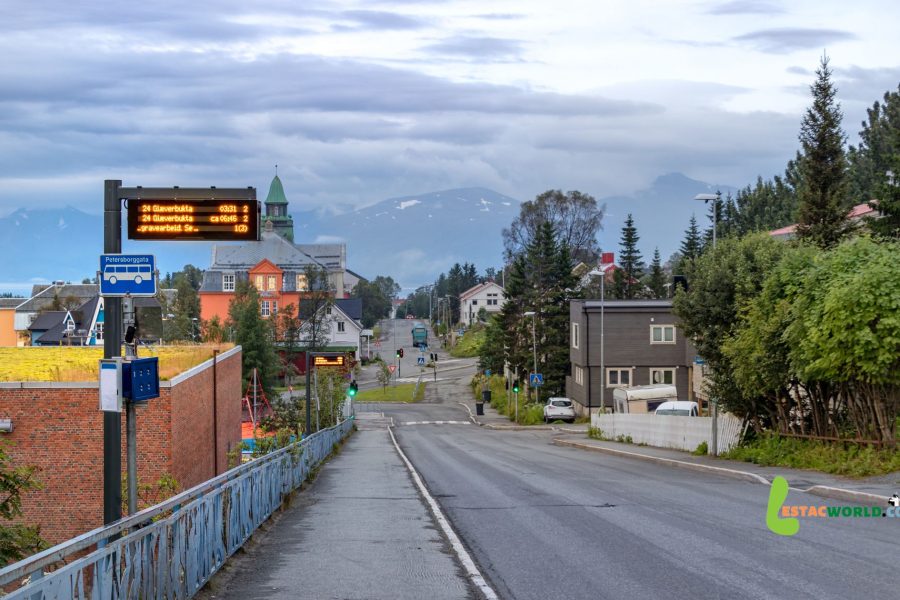 A scenic road leading towards Tromso, flanked by majestic mountains and fjords, symbolizing the picturesque journey from Kiruna to Tromso via cab transfers.