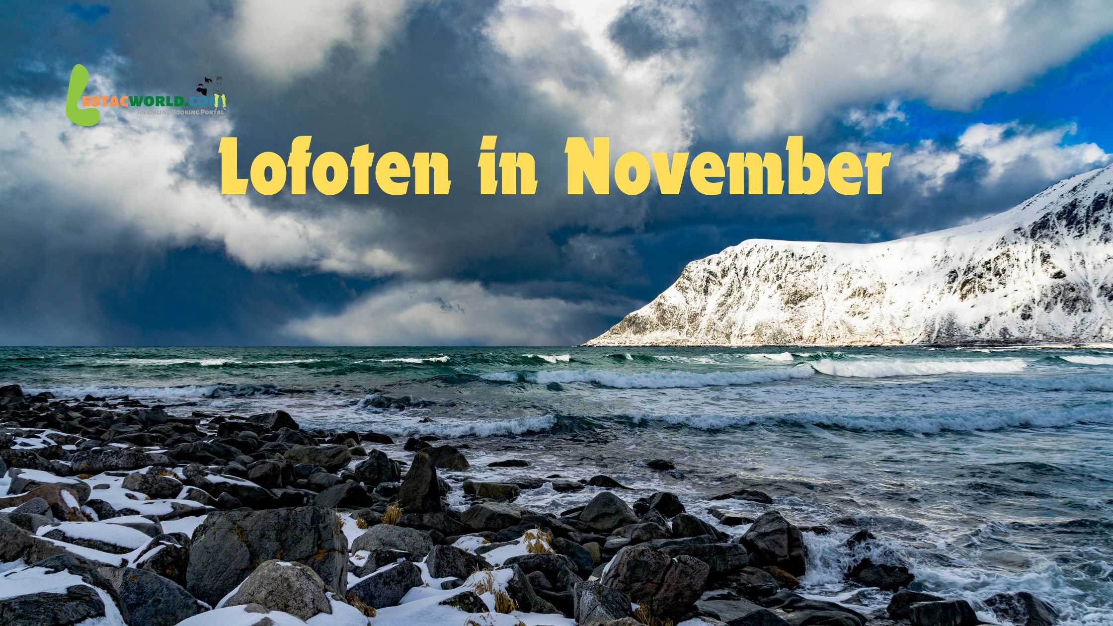 Seashore with scattered snow-covered stones and snowy Alps in the background in Lofoten during November.