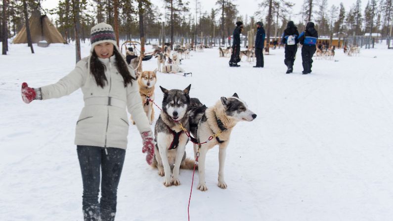Mei Ling enjoying with huskies in snowy Rovaniemi, Finland during her tour from Malaysia.