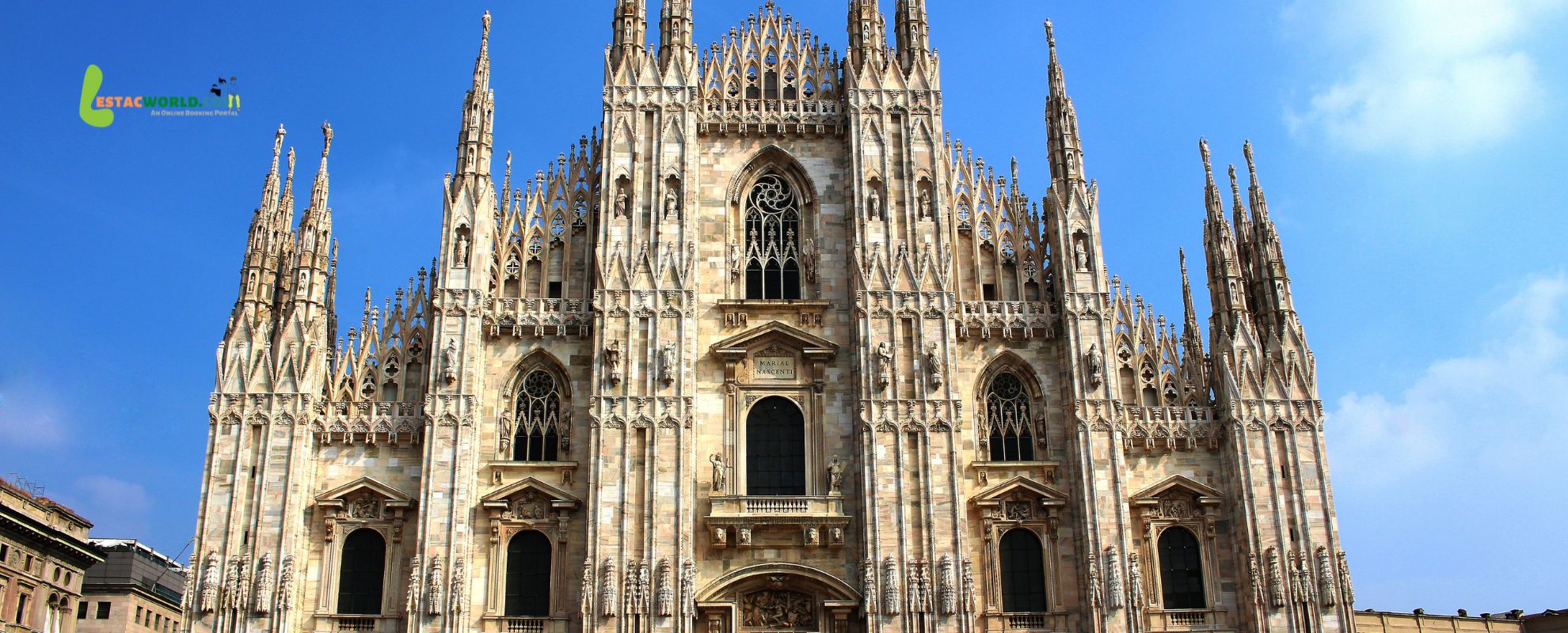 The Duomo di Milano, a magnificent Gothic cathedral with intricate spires and statues, stands under a partly cloudy sky with autumn leaves scattered around the square.