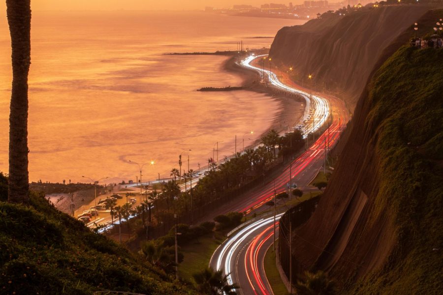 Lima highway by the sea during sunset, viewed from the coast on the 9 nights 10 days Peru tour package.